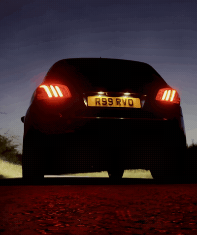 A Black Car With A License Plate That Says R99 Rvd GIF