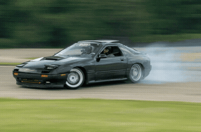 A Black Car With A Sticker On The Windshield That Says ' Rx7 ' On It GIF