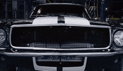 A Black Car With A White Stripe On The Hood GIF