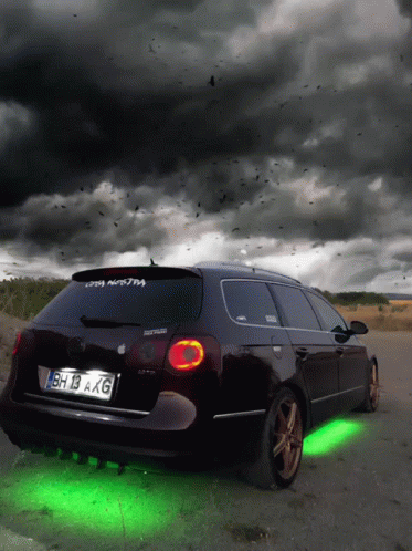 A Black Car With License Plate Bh 13 Axg Is Parked On The Side Of The Road GIF