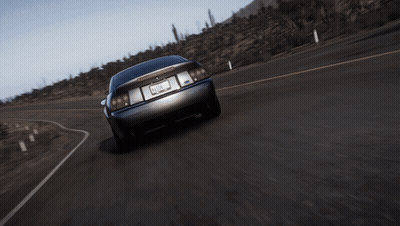 A Black Car With The Number 2 On The Side Is Driving Down The Road GIF