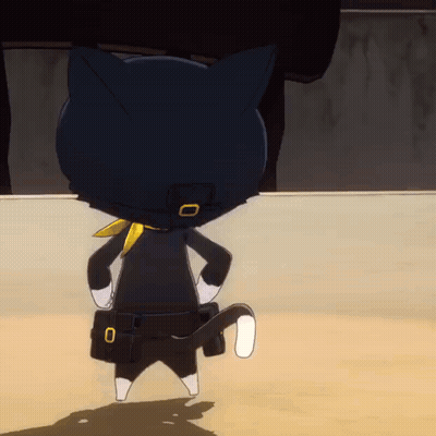 A Black Cat With A Yellow Scarf Around Its Neck Is Standing On A Sandy Surface GIF