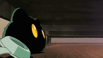 A Black Cat With Yellow Eyes Is Laying Under A Bed GIF