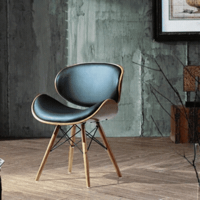 A Black Chair With Wooden Legs Is Sitting On A Wooden Floor GIF