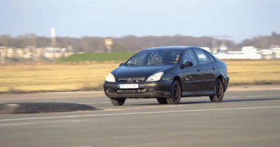 A Black Citroen Car With A License Plate That Says Tc - Nc - Nk Is Driving Down A Road GIF