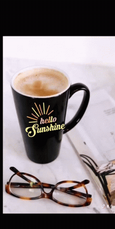 A Black Coffee Mug That Says Hello Sunshine On It GIF