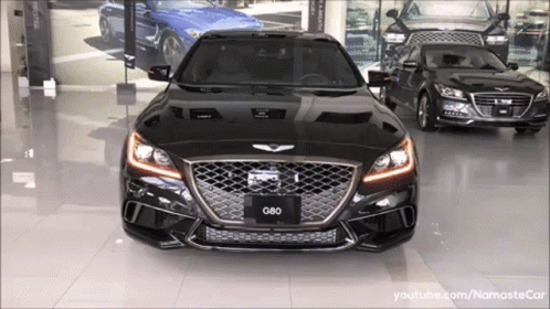 A Black G80 Is Parked In A Showroom GIF