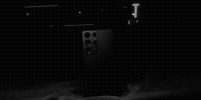 A Black Galaxy S21 Ultra Phone Is Sitting On A Table . GIF