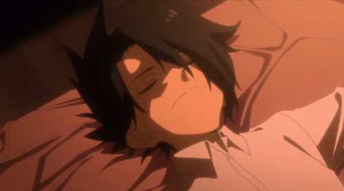 A Black Haired Anime Character Is Laying Down With His Eyes Closed GIF