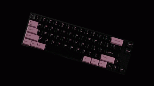 A Black Keyboard With Pink Keys Has The Shift Key On The Bottom Left GIF