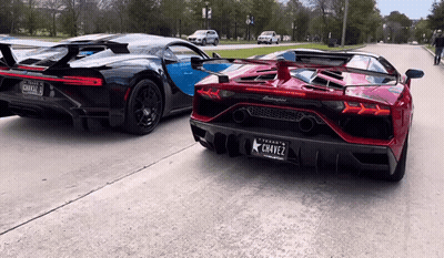 A Black Lamborghini Is Parked Next To A Red Lamborghini With A Texas License Plate GIF