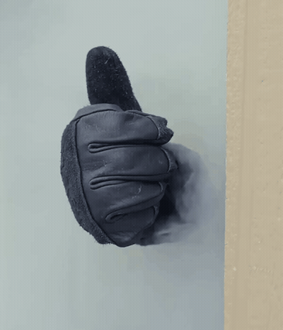 A Black Leather Glove Is Giving A Thumbs Up GIF