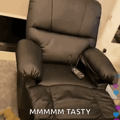 A Black Leather Recliner With A Remote Control And The Words Mmmm Tasty On It GIF
