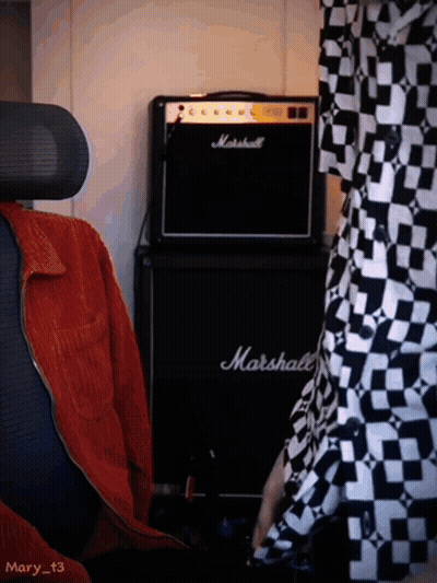 A Black Marshall Amplifier Sits In Front Of A Person GIF