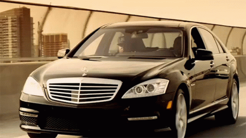 A Black Mercedes Is Parked On A Bridge GIF