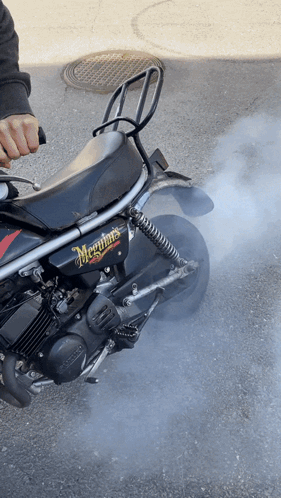 A Black Motorcycle With Meguiar 'S Written On The Side Of It GIF