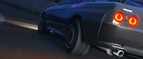 A Black Nissan Sports Car Is Driving Down A Road GIF