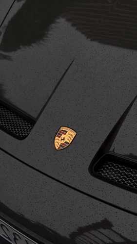 A Black Porsche With A License Plate That Says A338 GIF