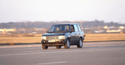 A Black Range Rover Is Driving Down A Road With A License Plate That Says Jc - Nc - 88 GIF