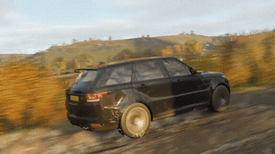 A Black Range Rover Is Driving On A Dirt Road . GIF