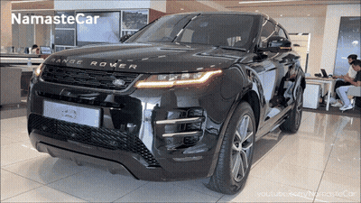 A Black Range Rover Sits In A Showroom GIF