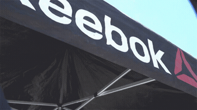 A Black Reebok Tent With A White Logo On It GIF