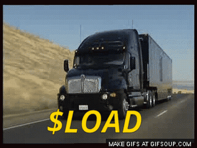 A Black Semi Truck Is Driving Down A Highway With The Words $ Load In Yellow GIF