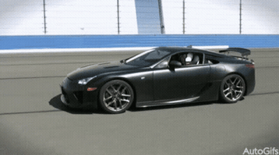 A Black Sports Car Is Driving On A Track With Autogifs Written In The Corner GIF