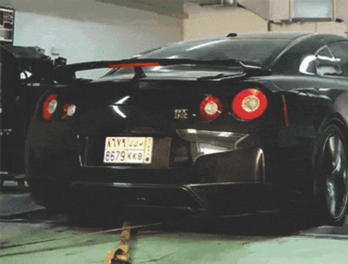 A Black Sports Car With A License Plate That Says 8679Kk8 GIF