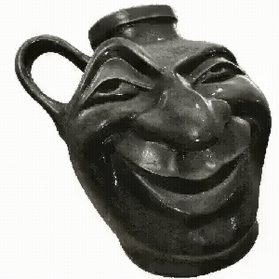 A Black Vase With A Smiling Face Carved Into It . GIF