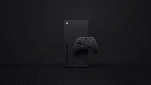 A Black Xbox Series X Console With A Black Controller On A Black Background . GIF