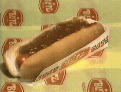 A Blitz Hot Dog Is Sitting On A Yellow Surface GIF