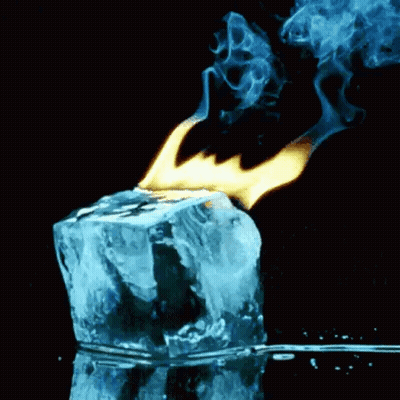 A Block Of Ice Is Being Lit Up By A Flame . GIF