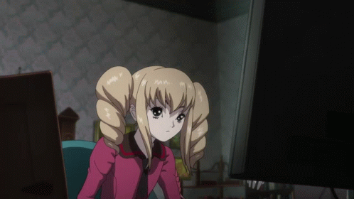 A Blonde Anime Girl With Pigtails Is Sitting In Front Of A Computer Monitor GIF