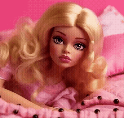 A Blonde Barbie Doll Is Laying On A Bed With Pink Pillows GIF