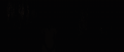 A Blonde Woman In A Pink Striped Shirt Looks At The Camera GIF