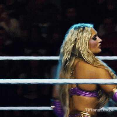 A Blonde Woman In A Purple Top Is In A Boxing Ring With Tiffany Ev24 Written On The Bottom Right GIF