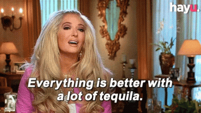A Blonde Woman Is Sitting In A Living Room And Says Everything Is Better With A Lot Of Tequila . GIF