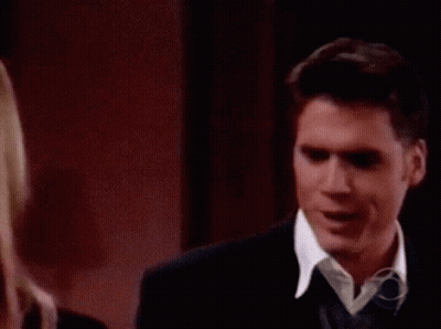 A Blonde Woman Is Smiling In A Living Room GIF