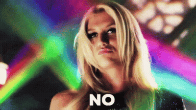 A Blonde Woman Is Standing In Front Of A Colorful Background And Says No . GIF