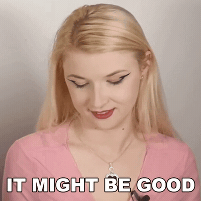 A Blonde Woman Is Wearing A Pink Shirt And Necklace And Says It Might Be Good . GIF