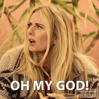 A Blonde Woman Says Oh My God While Holding A Glass Of Wine GIF