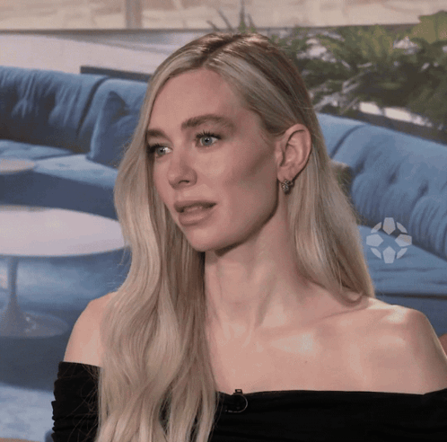 A Blonde Woman Wearing A Black Off The Shoulder Top GIF