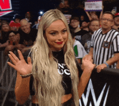 A Blonde Woman Wearing A Black Shirt That Says N' Uc GIF