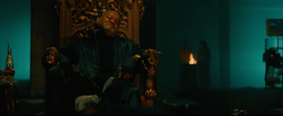 A Bloody Hand Is Reaching Out Towards A Man Sitting In A Chair GIF
