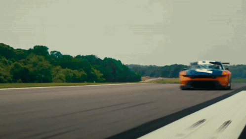 A Blue And Orange Race Car With The Number 7 On It GIF