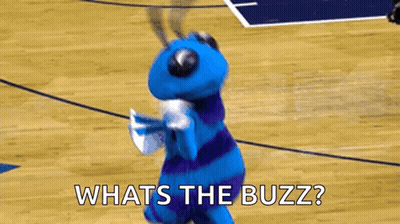 A Blue And Purple Mascot Is Dancing On A Basketball Court And Asking What 'S The Buzz ? GIF
