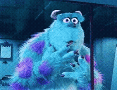 A Blue And Purple Monster From Monsters Inc Is Standing In A Room GIF