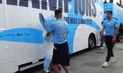 A Blue And White Bus With The Word Premier League On The Side GIF