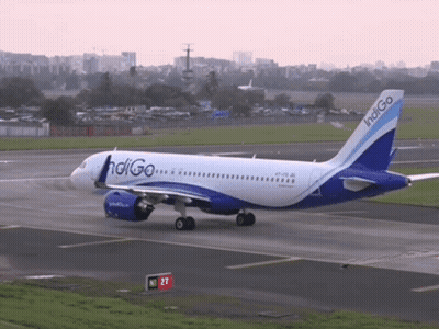 A Blue And White Indigo Airplane Is Taking Off From An Airport Runway GIF
